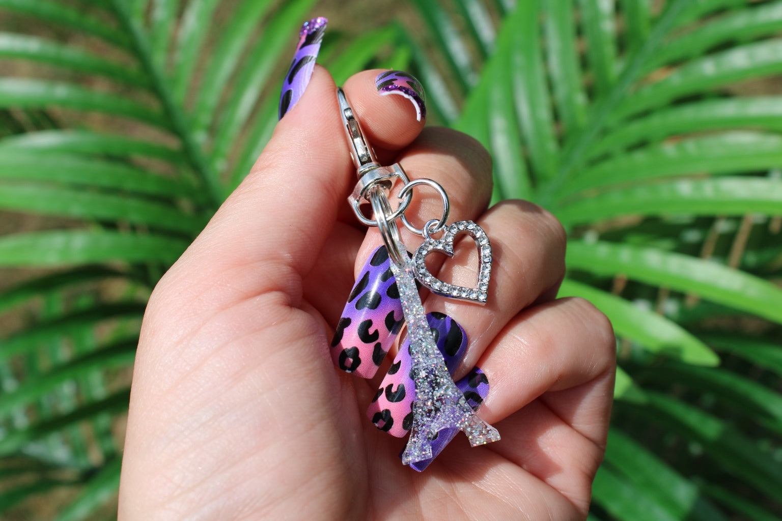 Eiffel Tower Keychain Held In A Manicured Hand