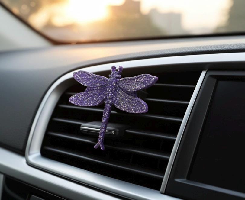 Purple dragonfly-shaped car vent clip.