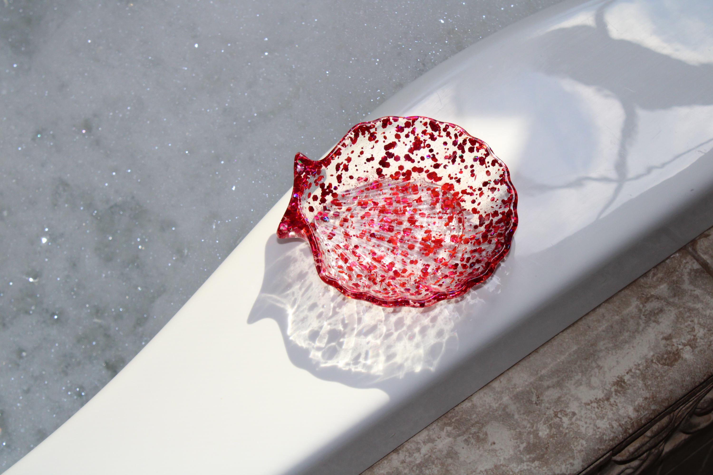 Seashell soap dish on the edge of a tub