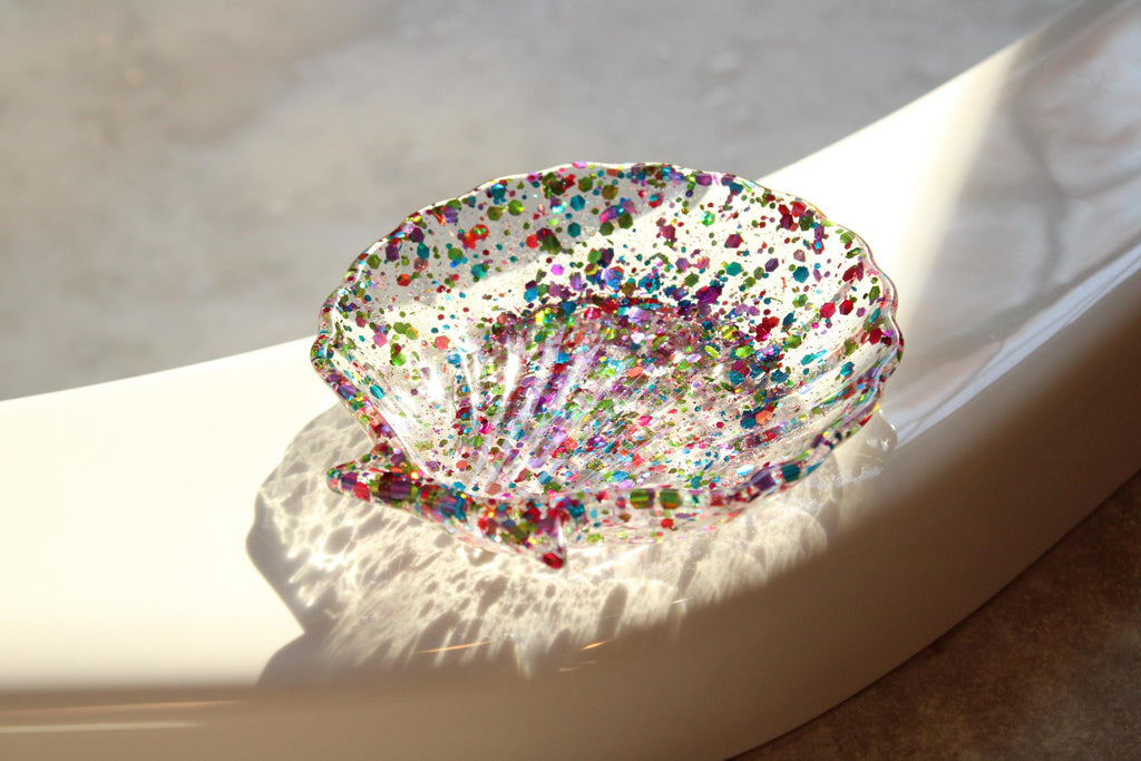 Colorful resin dish on a white surface with soft shadows