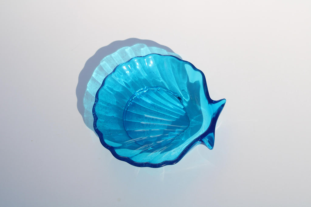 Blue seashell soap dish on a light gray background