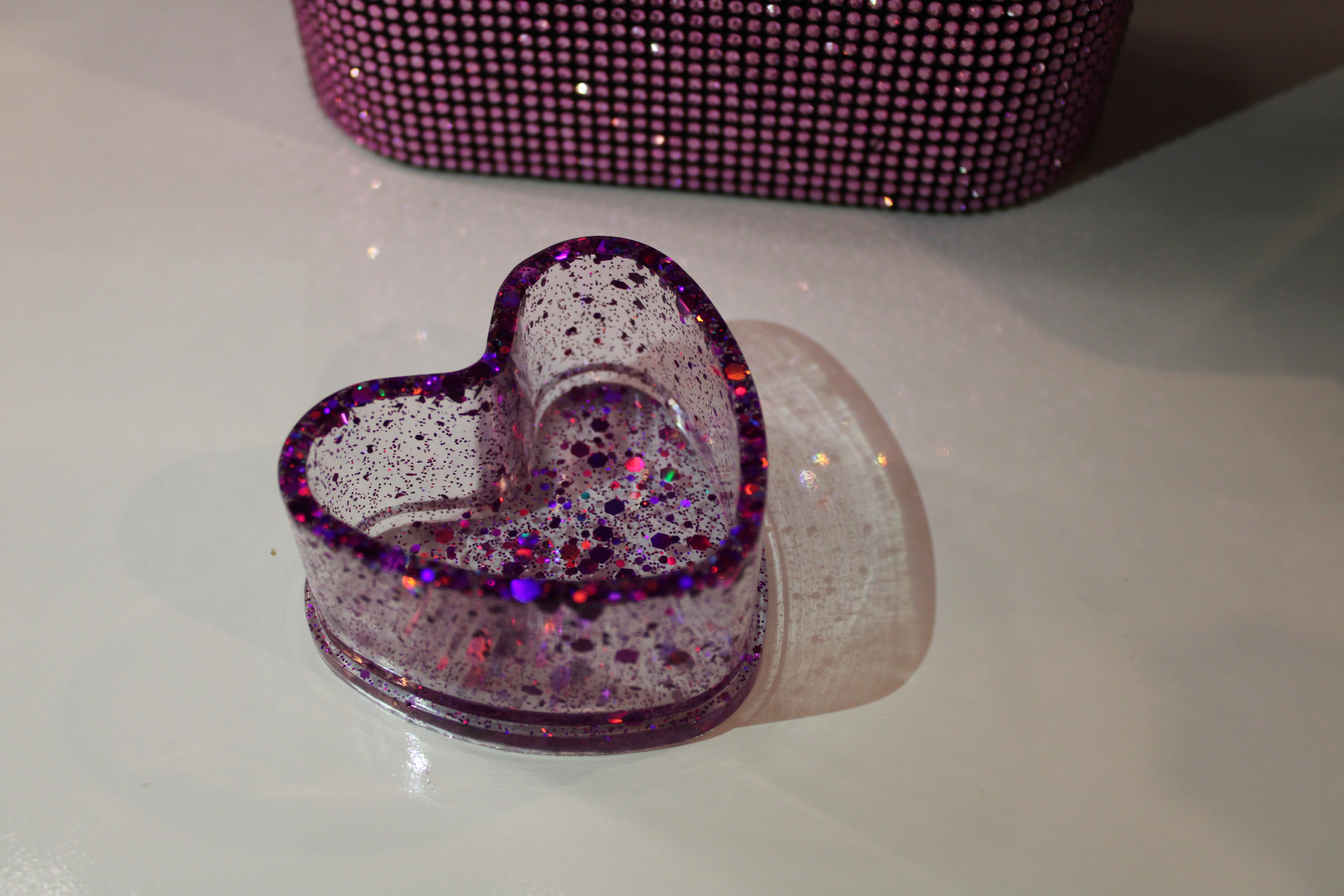 Heart ring dish with purple sequins on a vanity table
