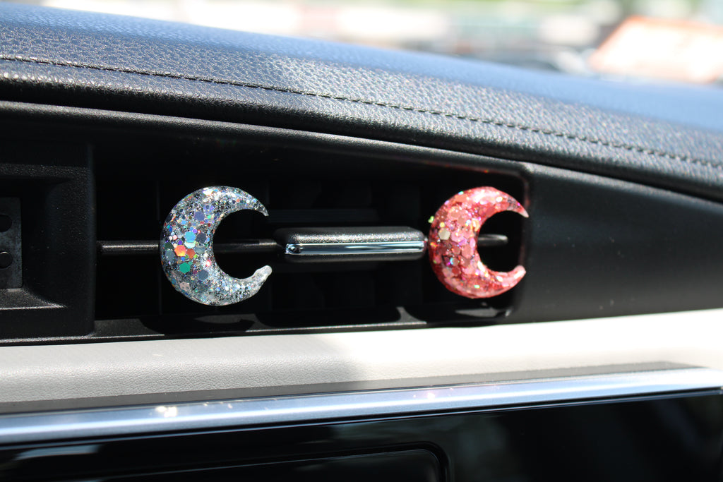 Moon design car vent clips on a car dashboard