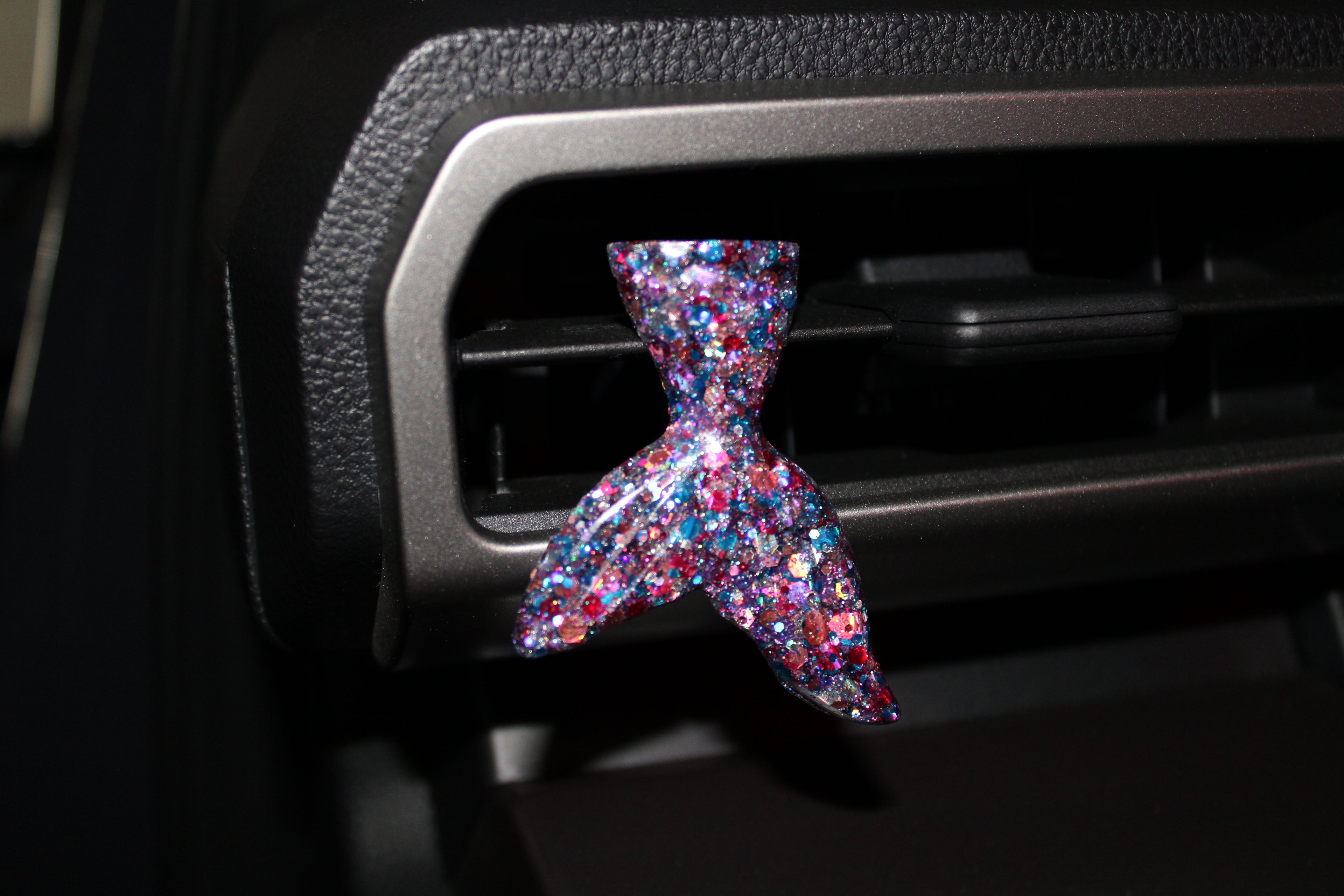 Multicolored glittery mermaid tail car vent clip on a cars air vent 