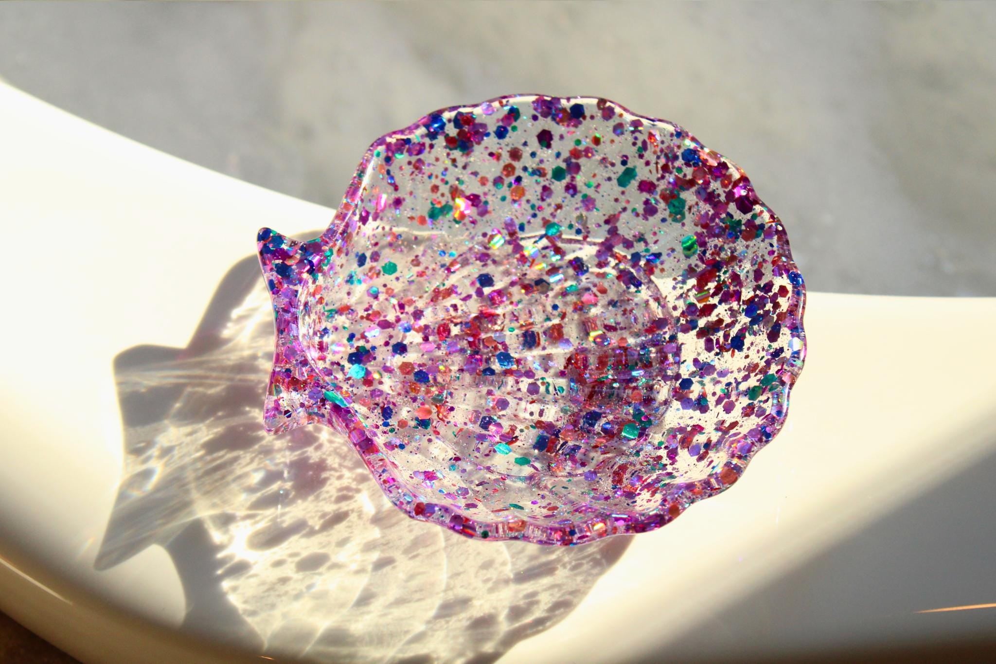 Colorful glittery soap dish on a light surface