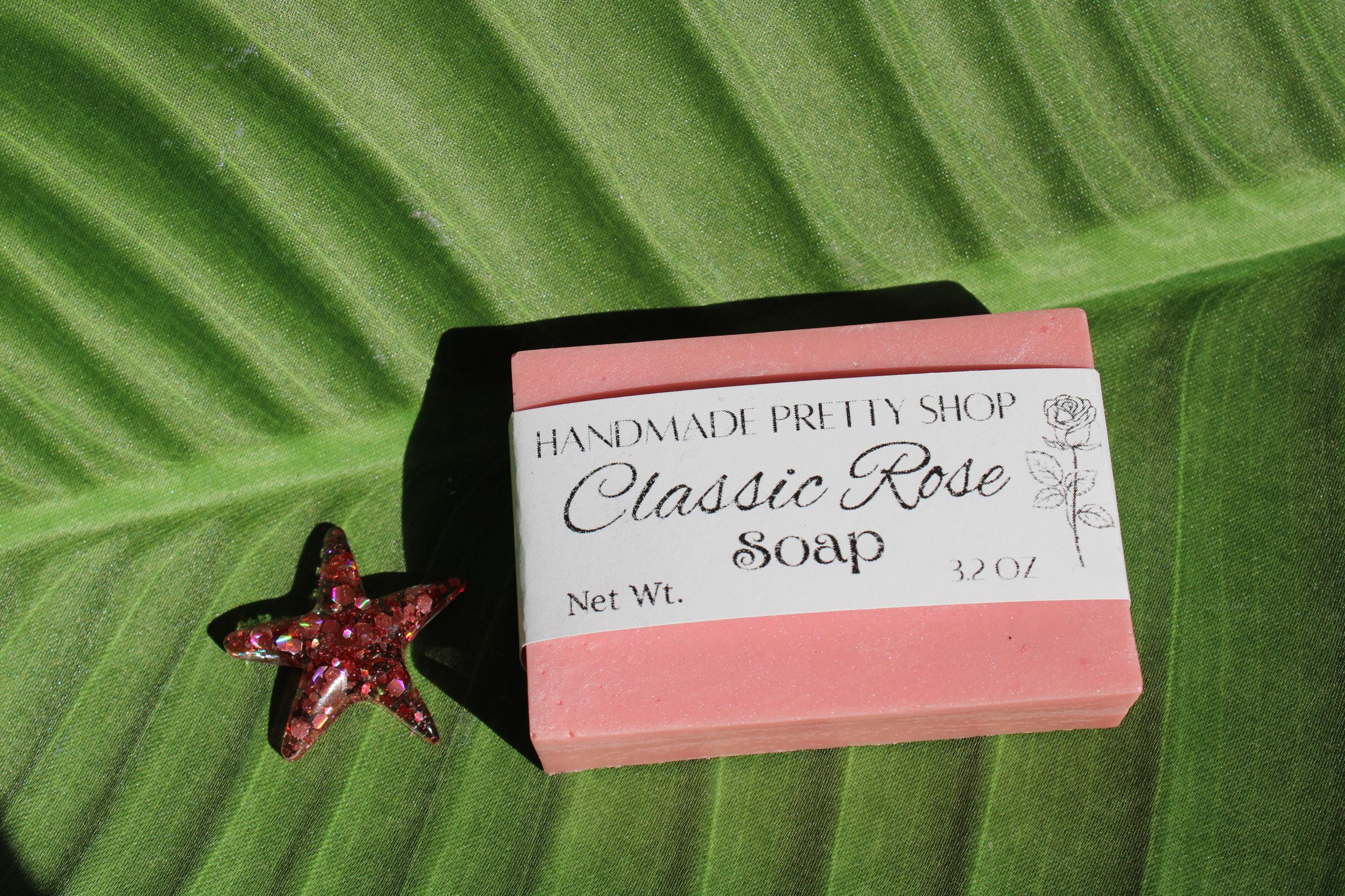 Bar of soap with a pink label on a green leaf background