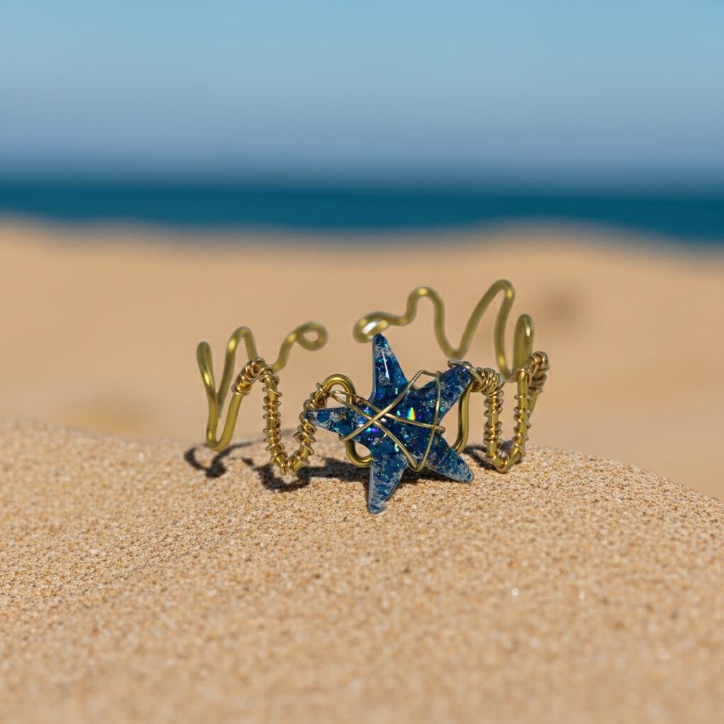 Decorative wire starfish bracelet on a sandy beach