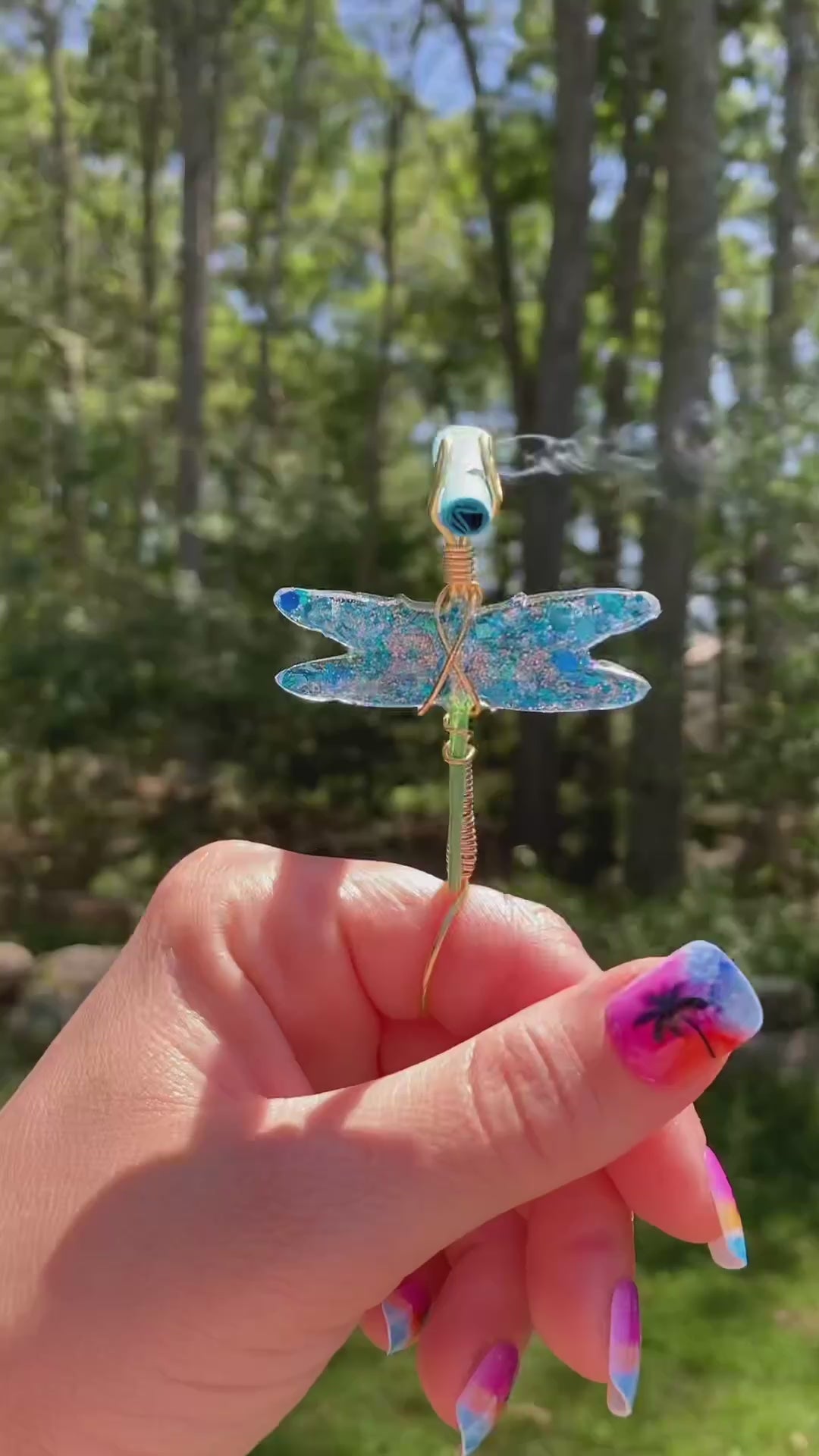 Video shows a blue sequin dragonfly smoke ring lit with a faux joint outside