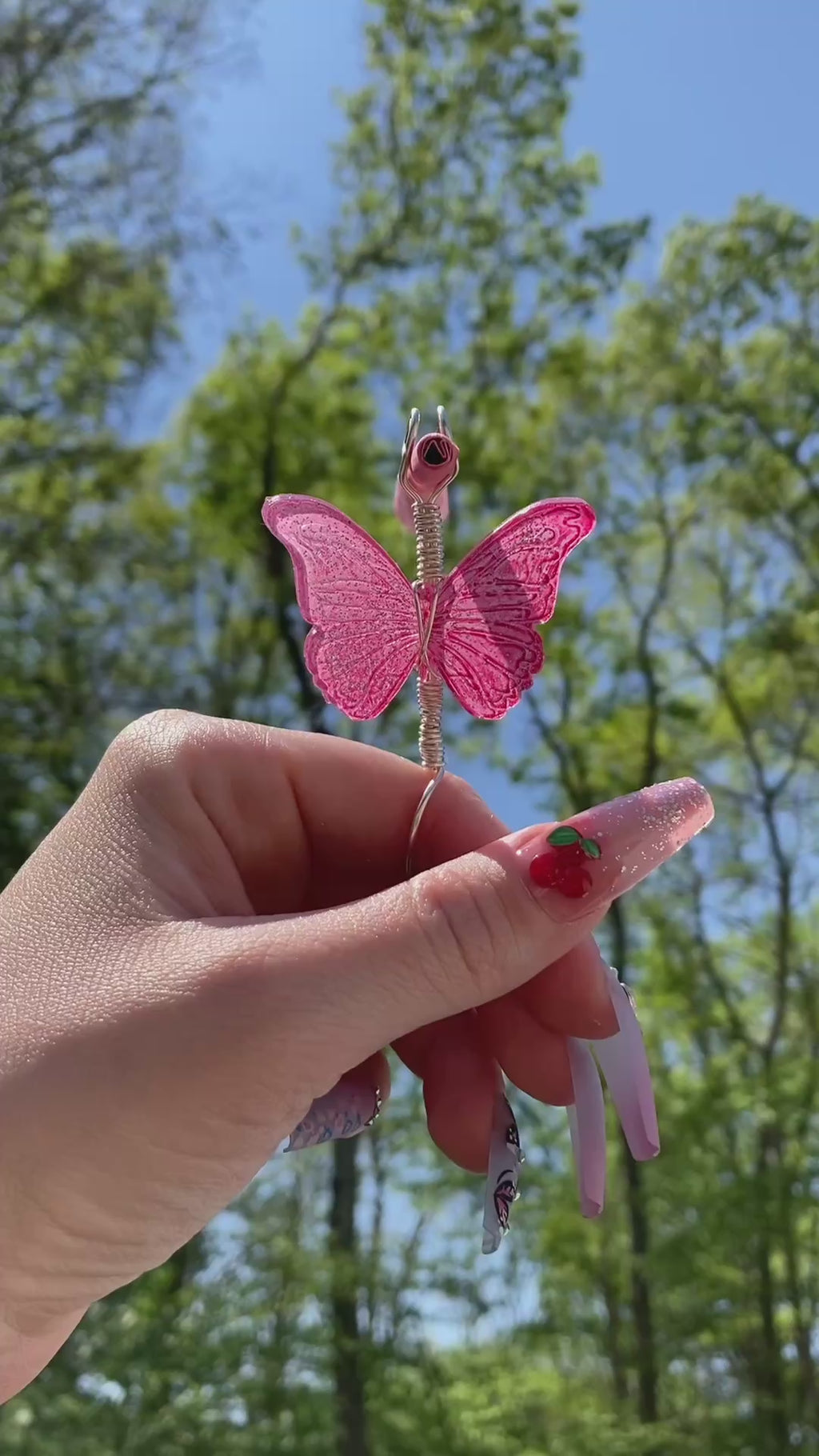 Video shows a pink butterfly smoke ring lit with a faux joint outside 