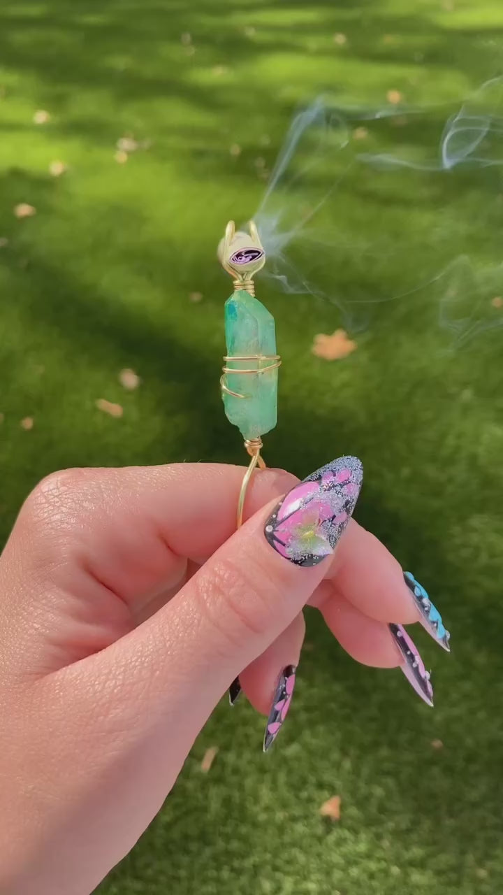 Video shows a green quartz crystal smoke ring lit with a faux joint in a nature setting