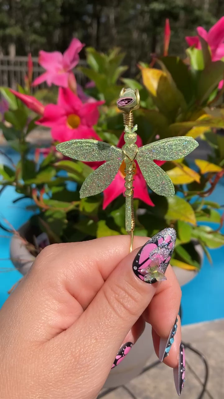 Video shows a dragonfly smoke ring lit with a faux lit joint in front of a pool