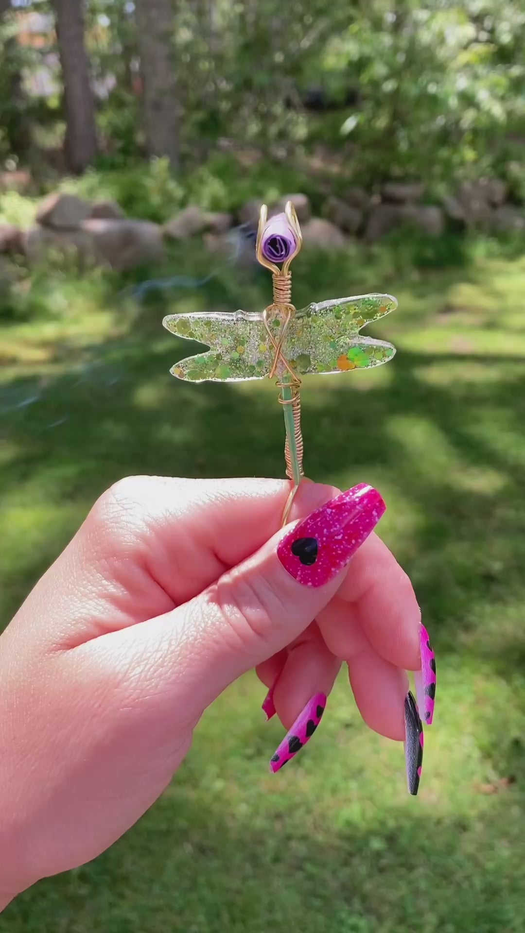 Video shows a green sequin dragonfly smoke ring with a lit faux joint outside 
