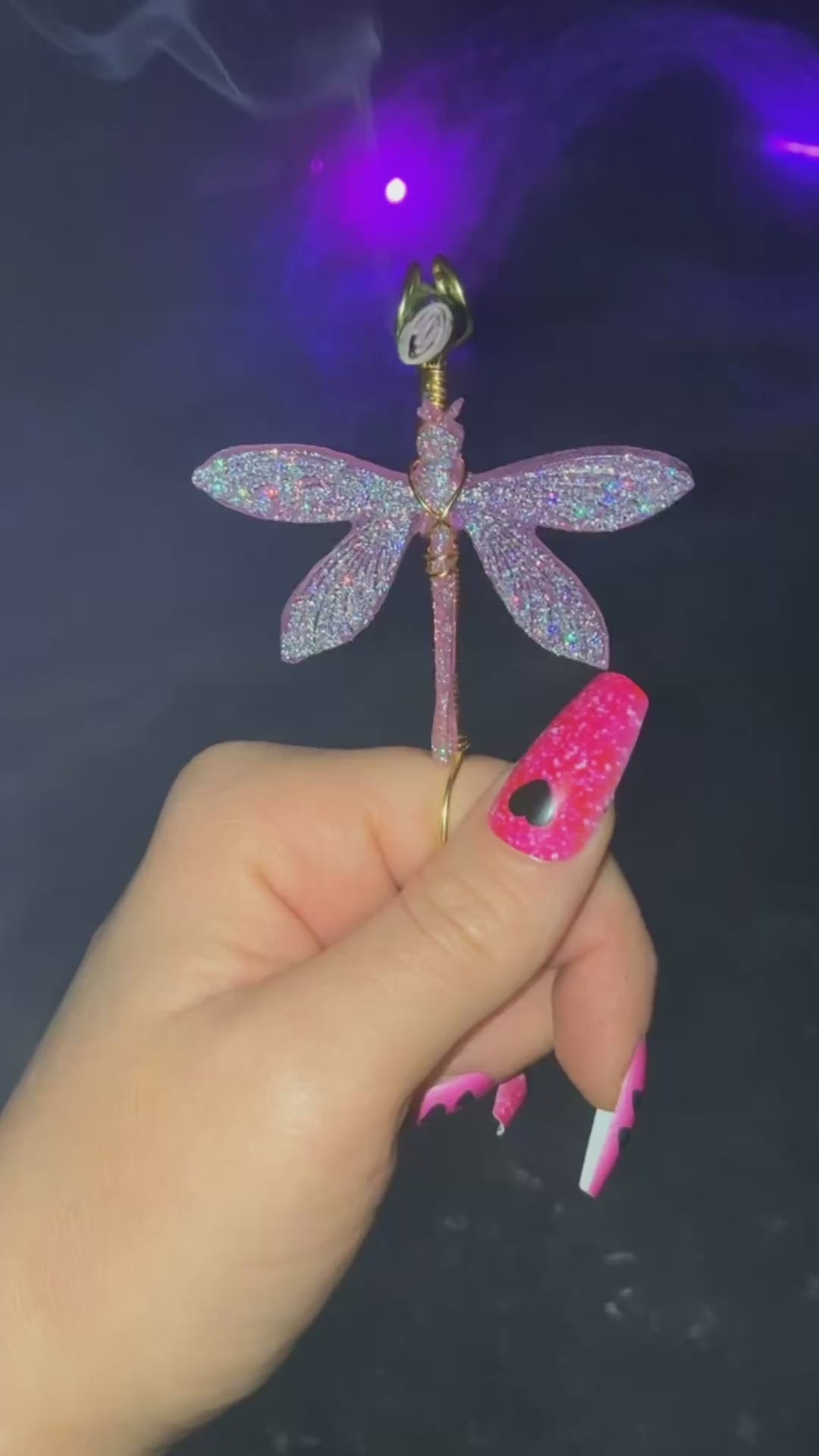 Pink sparkly dragonfly smoke ring with a lit faux joint.