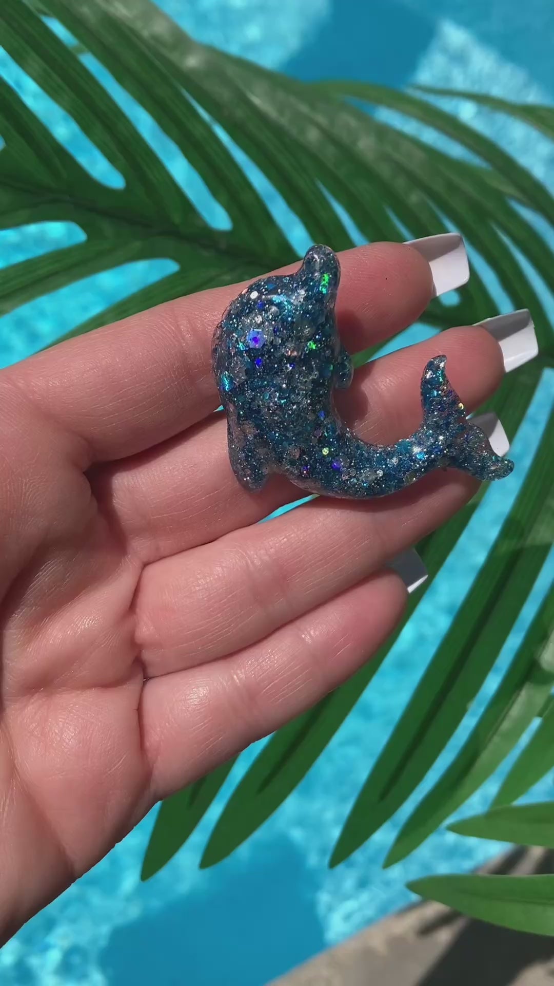 Video shows a blue sequin dolphin car vent clip