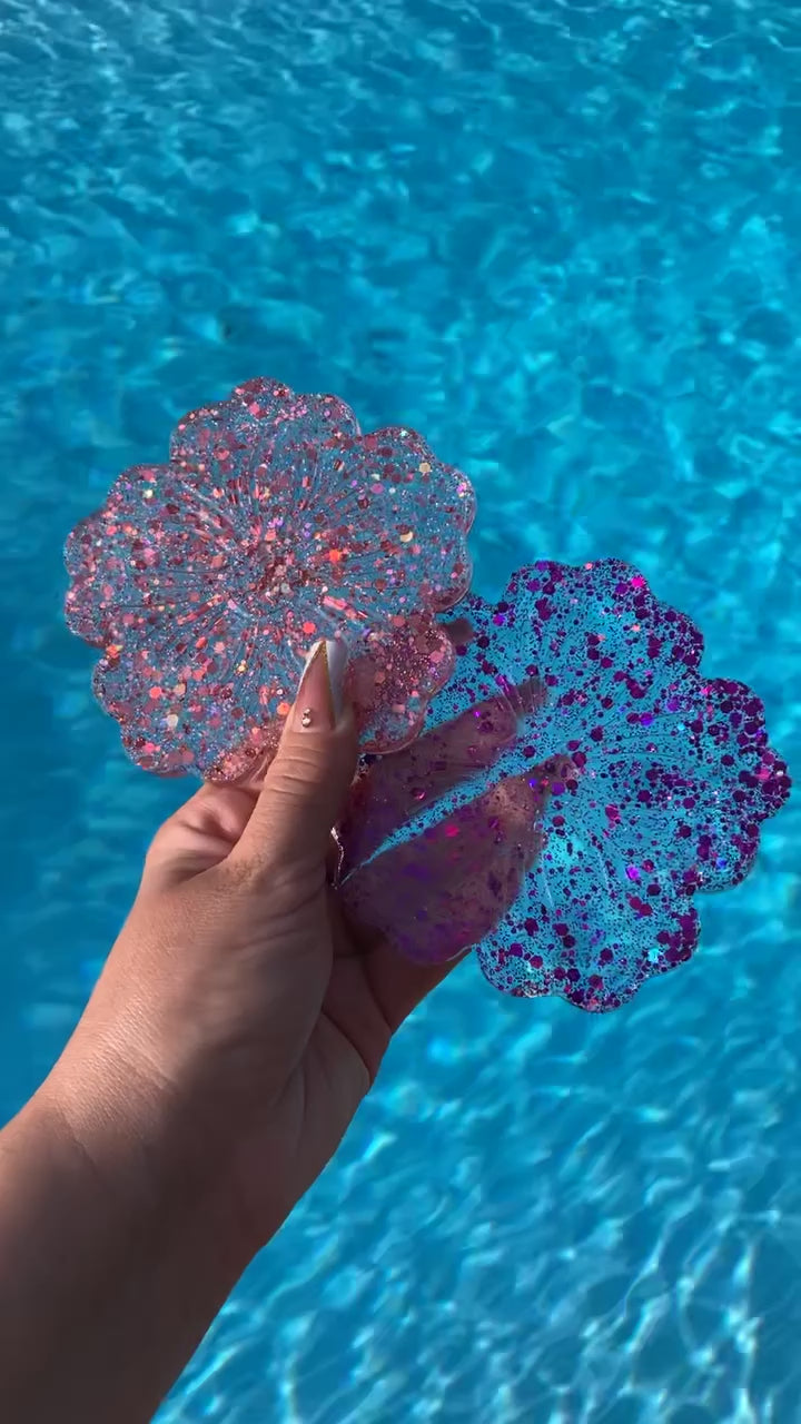 Video shows two flower drink coasters pink and purple sequins